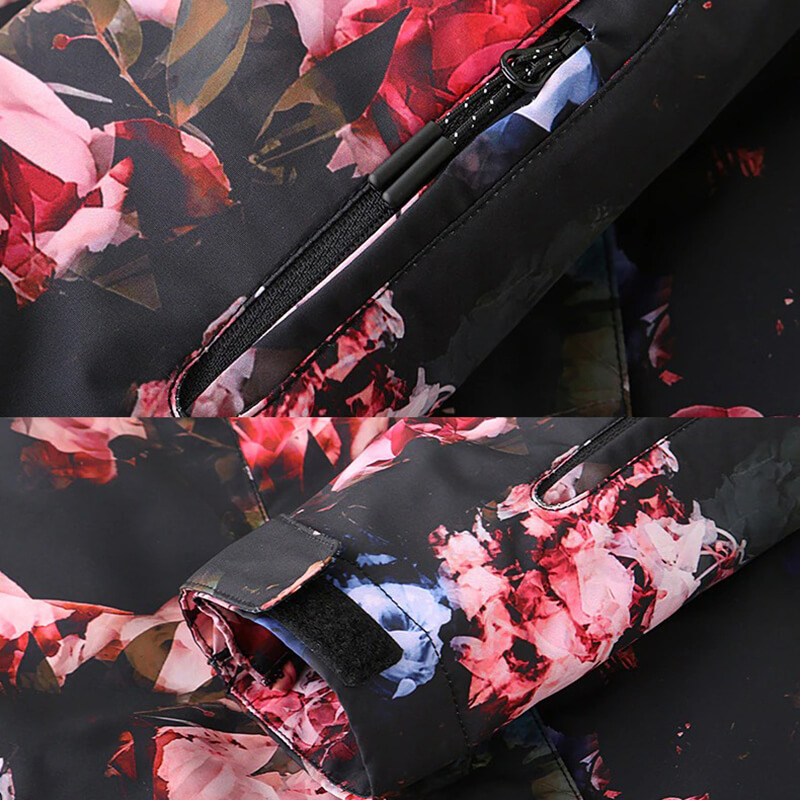 Close-up of stylish female waterproof jacket sleeve and zipper with floral pattern, perfect for skiing and snowboarding.